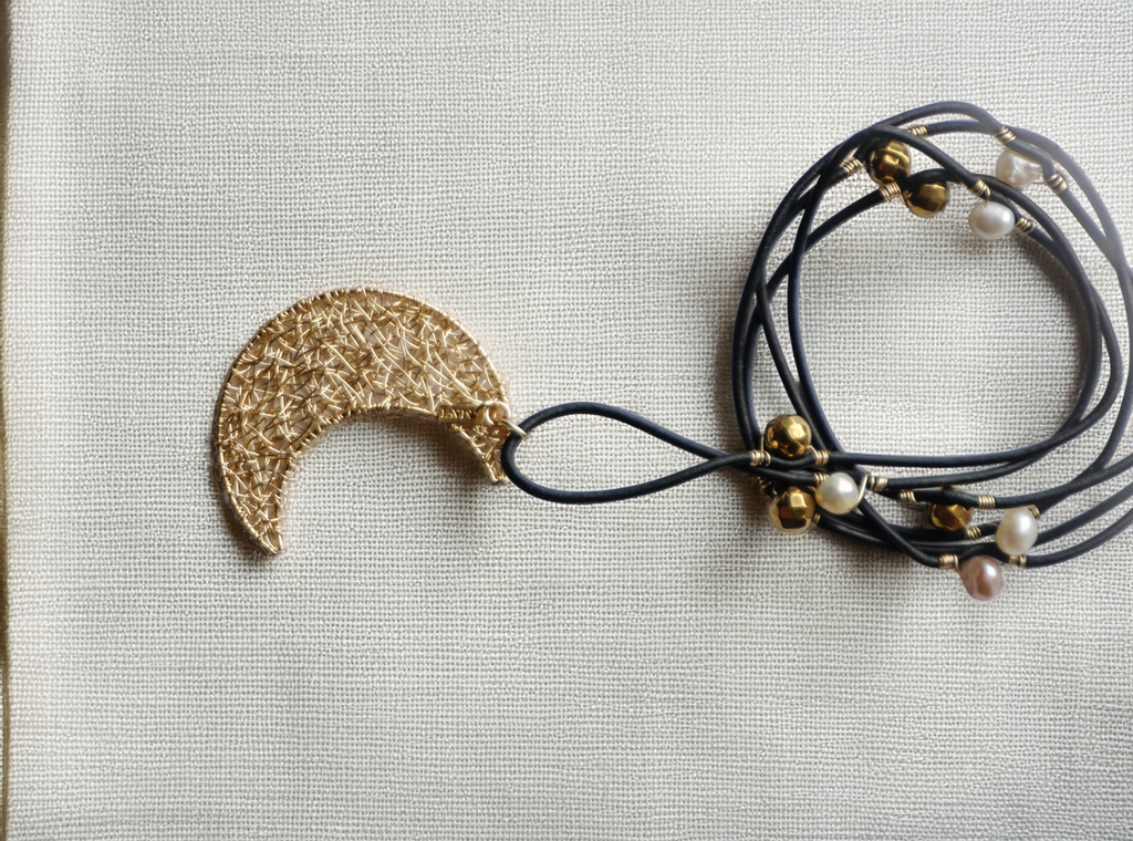 MoonCharm Lariat – Gold Crescent Pendant on Pearl-Accented Leather Wrap