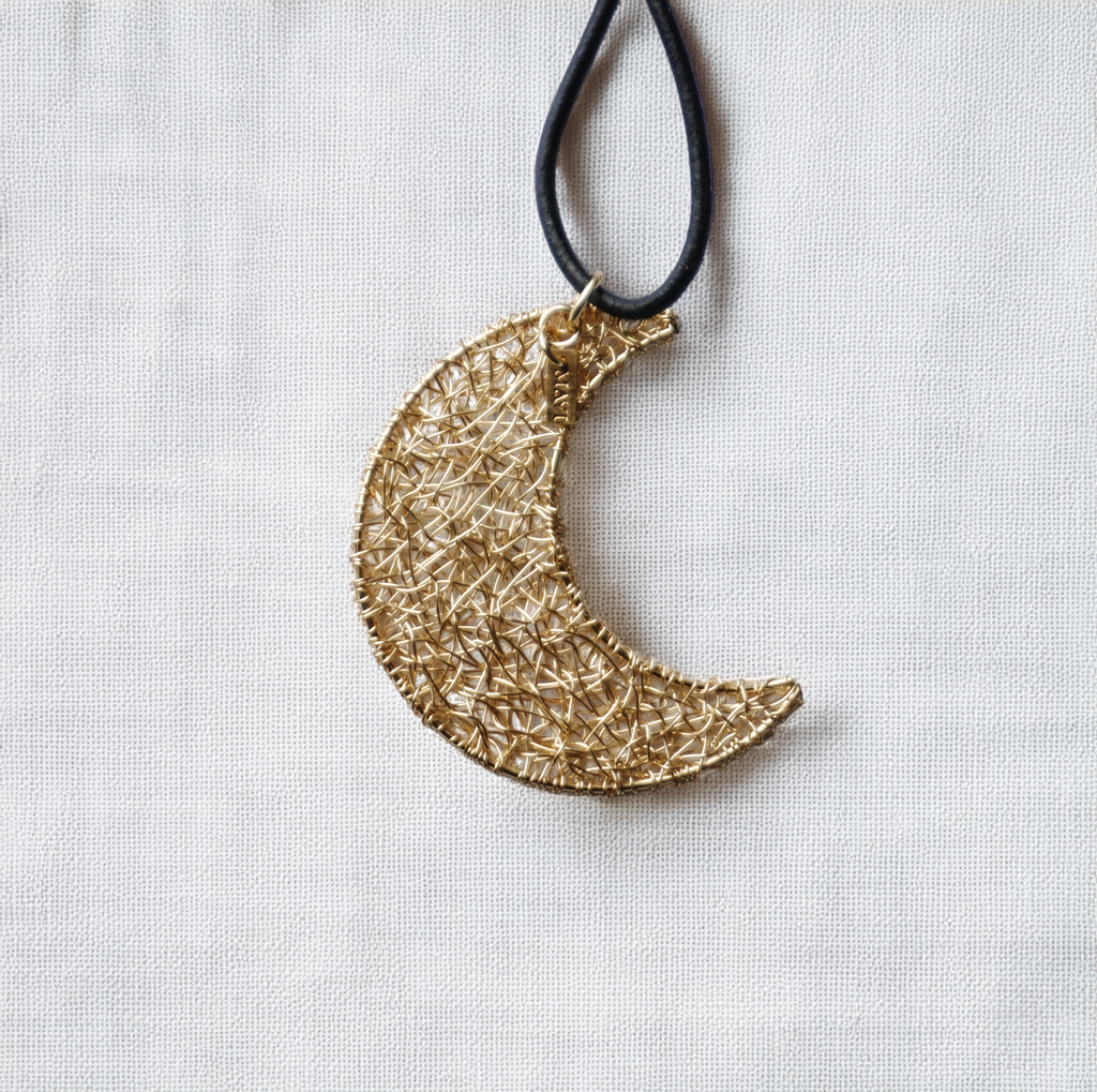 MoonCharm Lariat – Gold Crescent Pendant on Pearl-Accented Leather Wrap